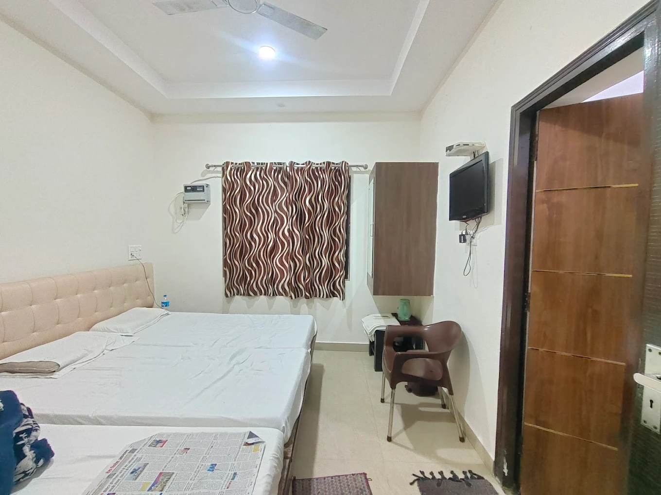 Tirumala guest room with television and double bed
